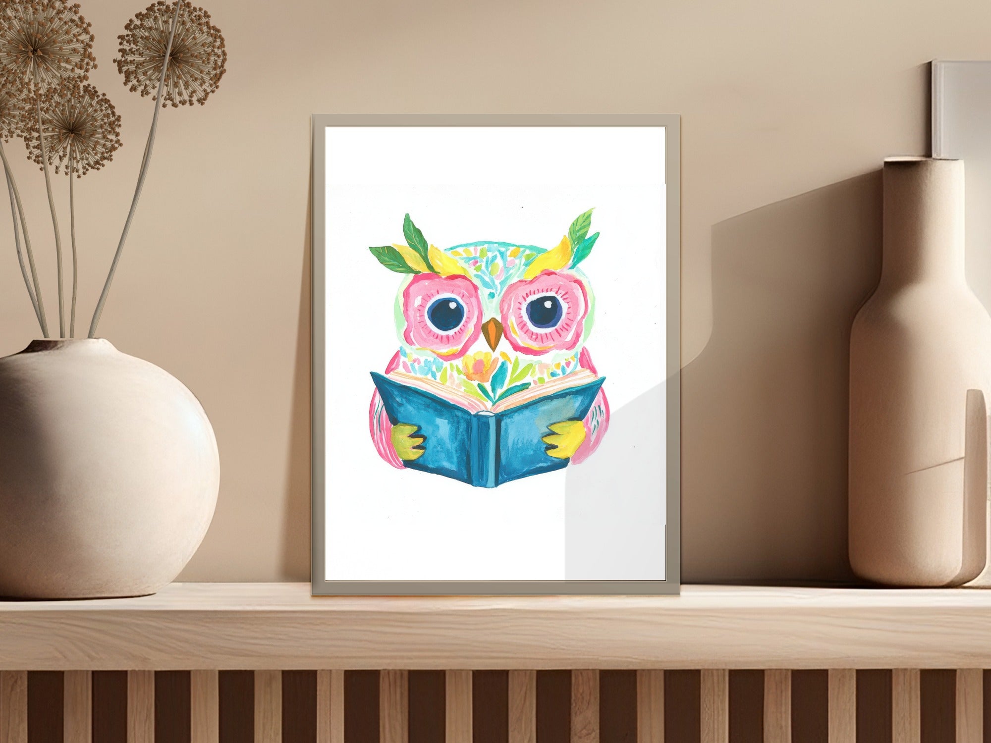 Watercolor owl with bright eyes reading an open book, framed.
