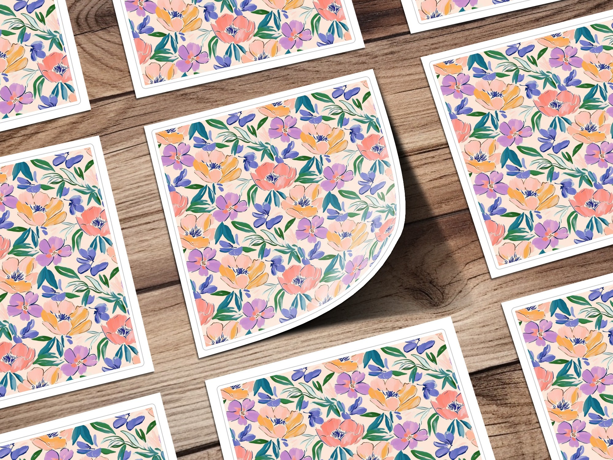 Floral pattern cards with pink, purple, and green flowers on a wooden background.