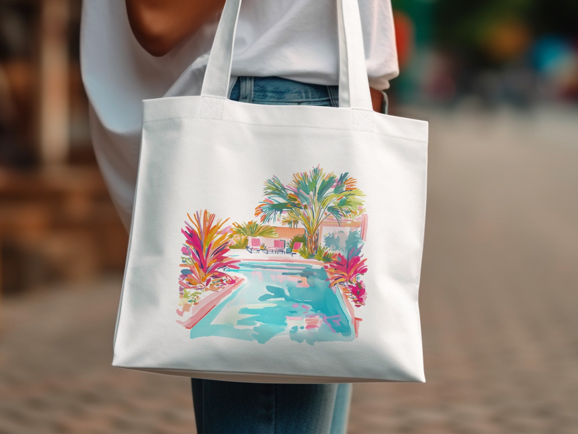 White tote bag with colorful watercolor illustration of a poolside scene.