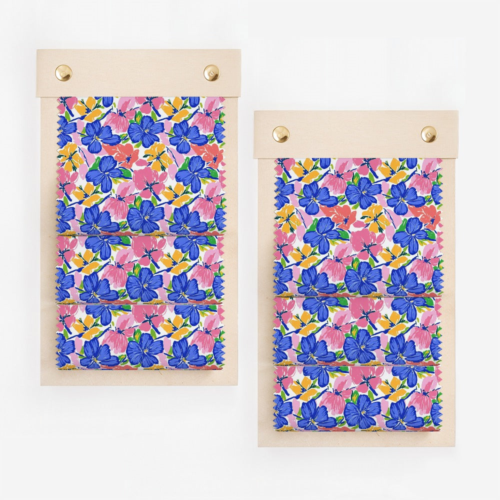 Two fabric swatches with a blue, pink, and yellow floral pattern on a white background.