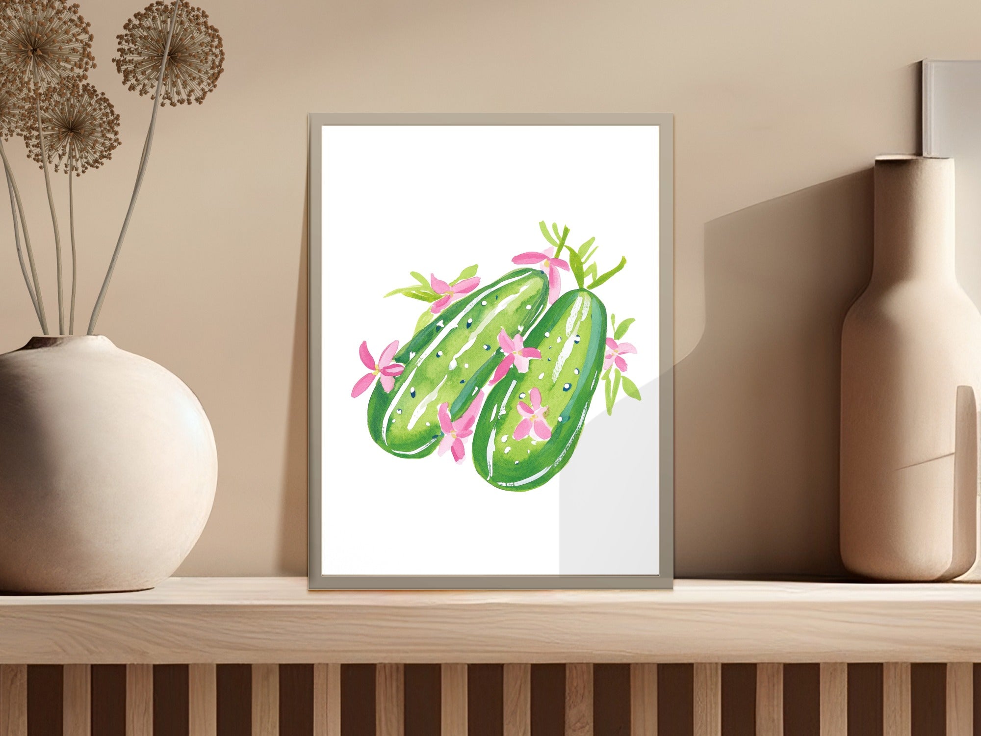 Watercolor illustration of two cucumbers with pink flowers and green leaves.