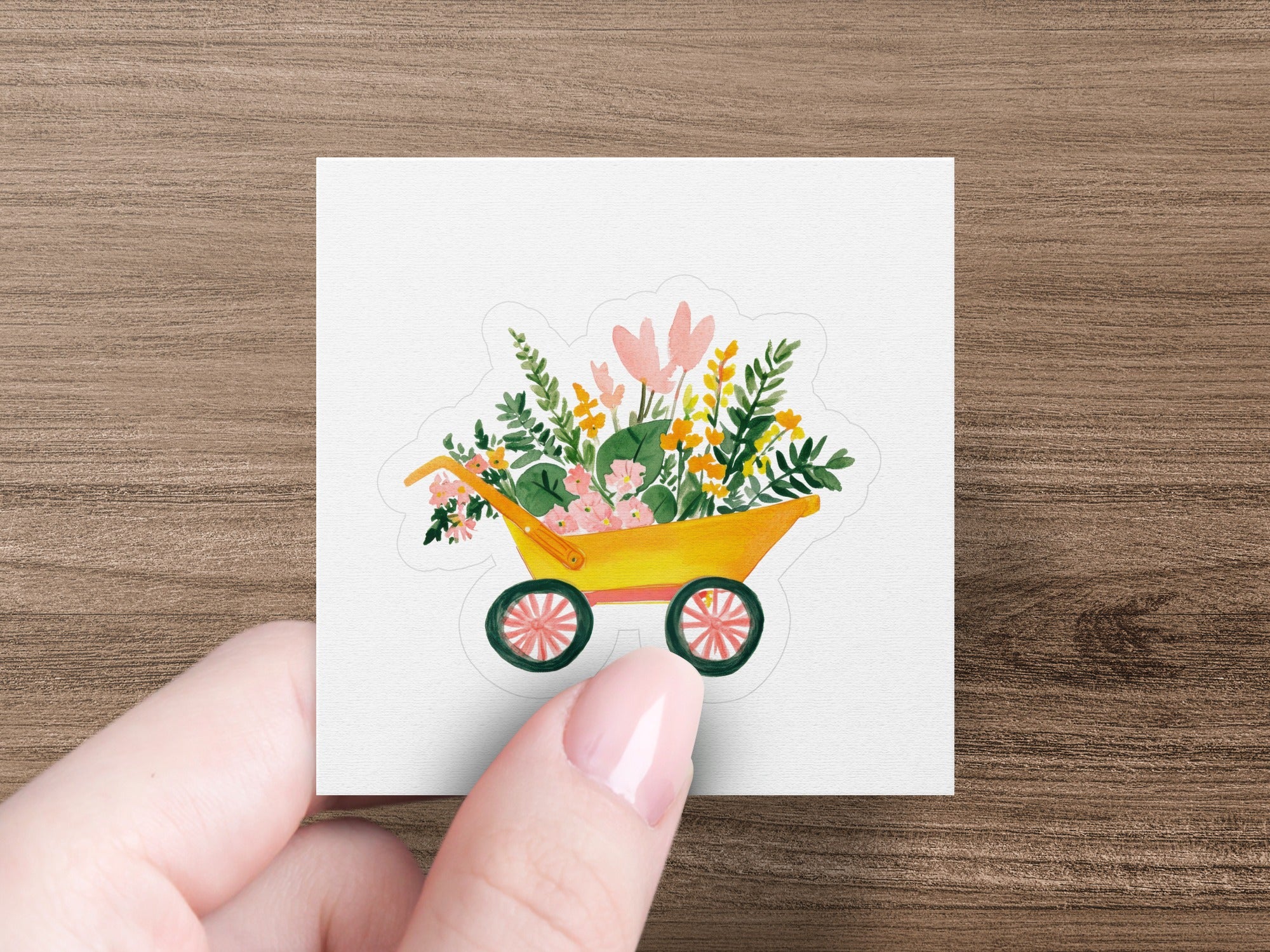 Yellow wheelbarrow sticker overflowing with colorful flowers and greenery.