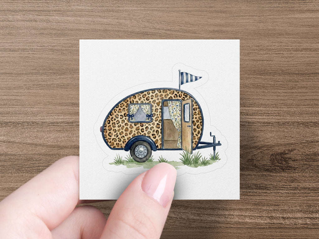 Leopard print camper trailer sticker with blue flag.