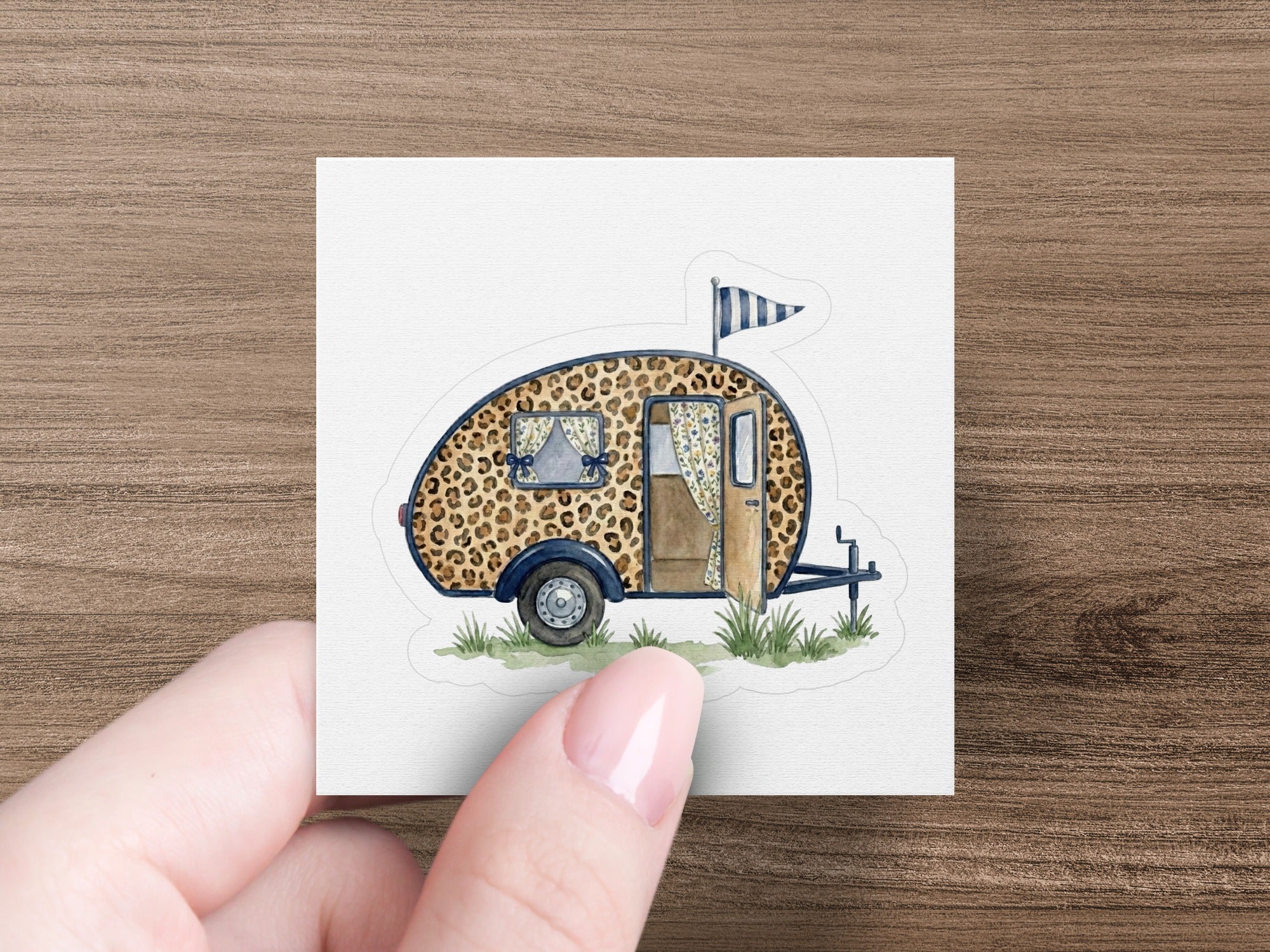 Leopard print camper trailer sticker with blue flag.