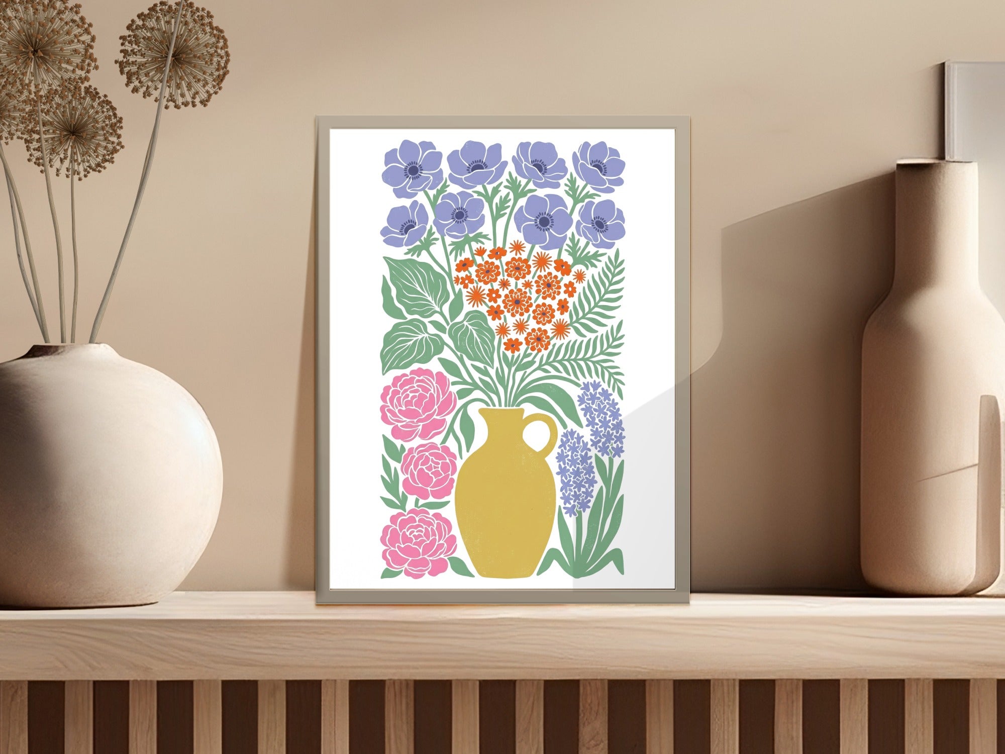 Floral arrangement in a yellow vase with blue and pink flowers on a shelf.