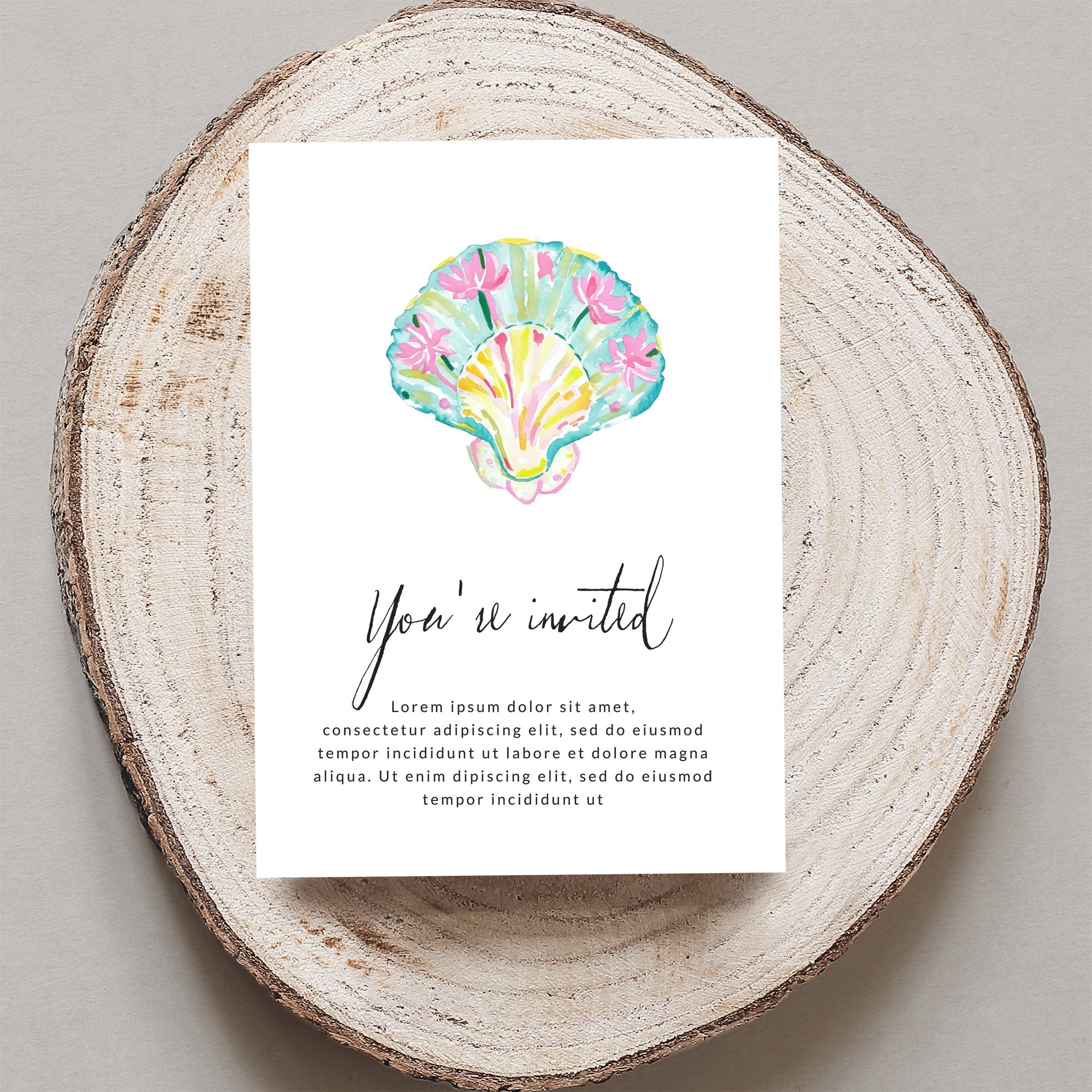 Watercolor seashell invitation with "You're invited" text.