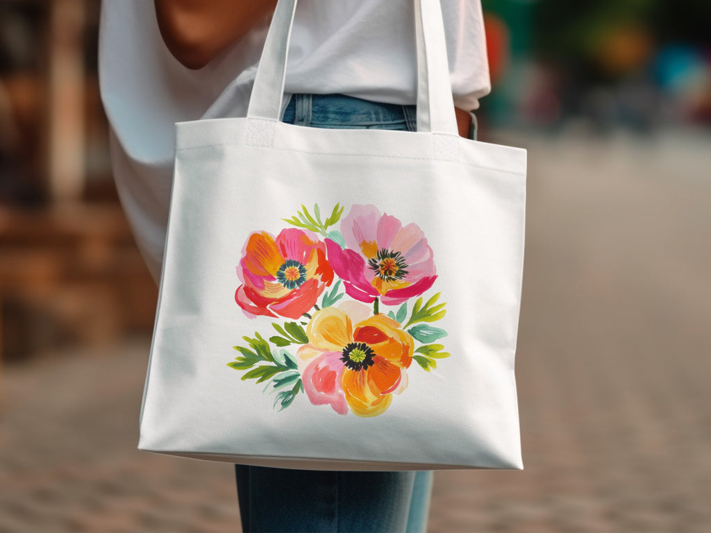 White tote bag featuring a colorful floral illustration of poppies and greenery.