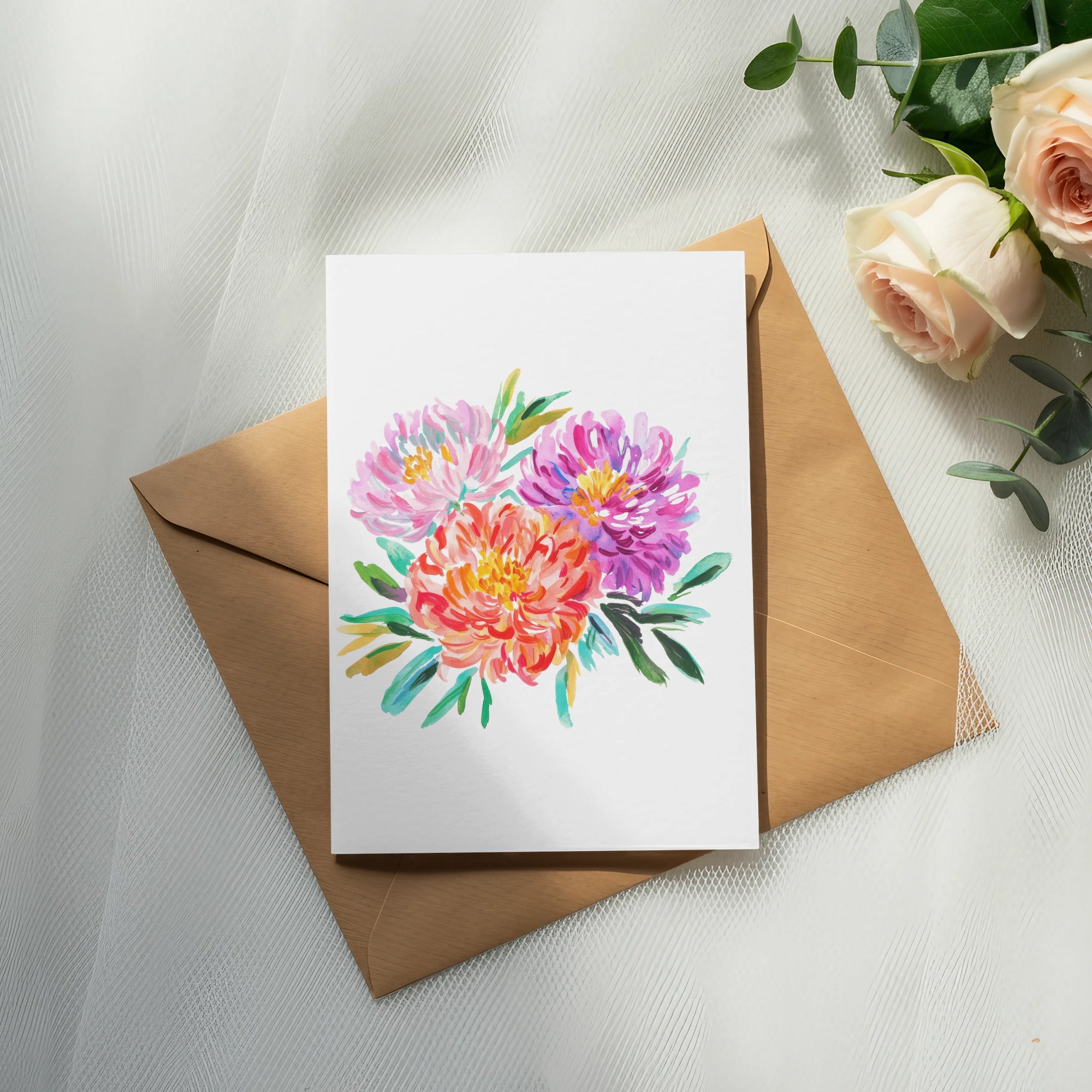 Watercolor floral illustration on a card atop a kraft envelope with roses.