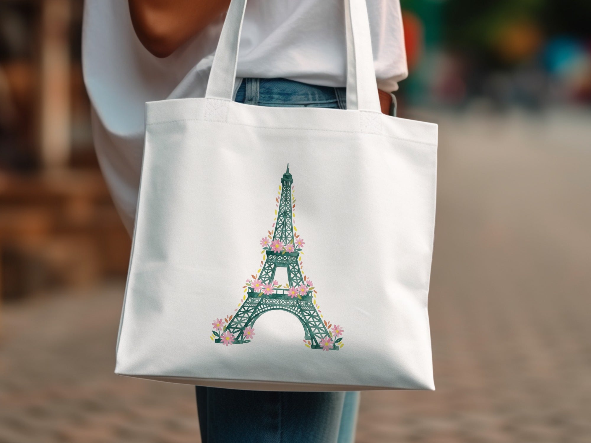 White tote bag with a floral Eiffel Tower design.