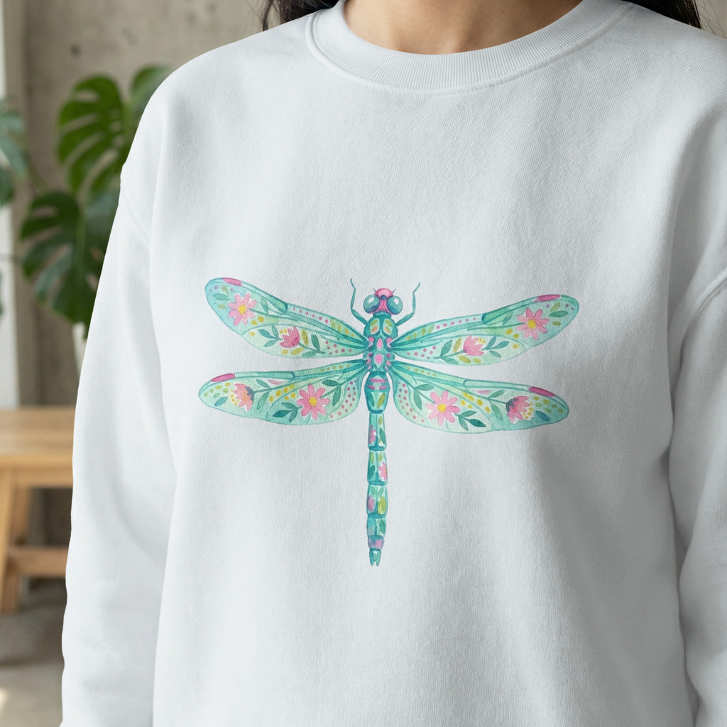 White sweatshirt with a colorful watercolor dragonfly and floral design.