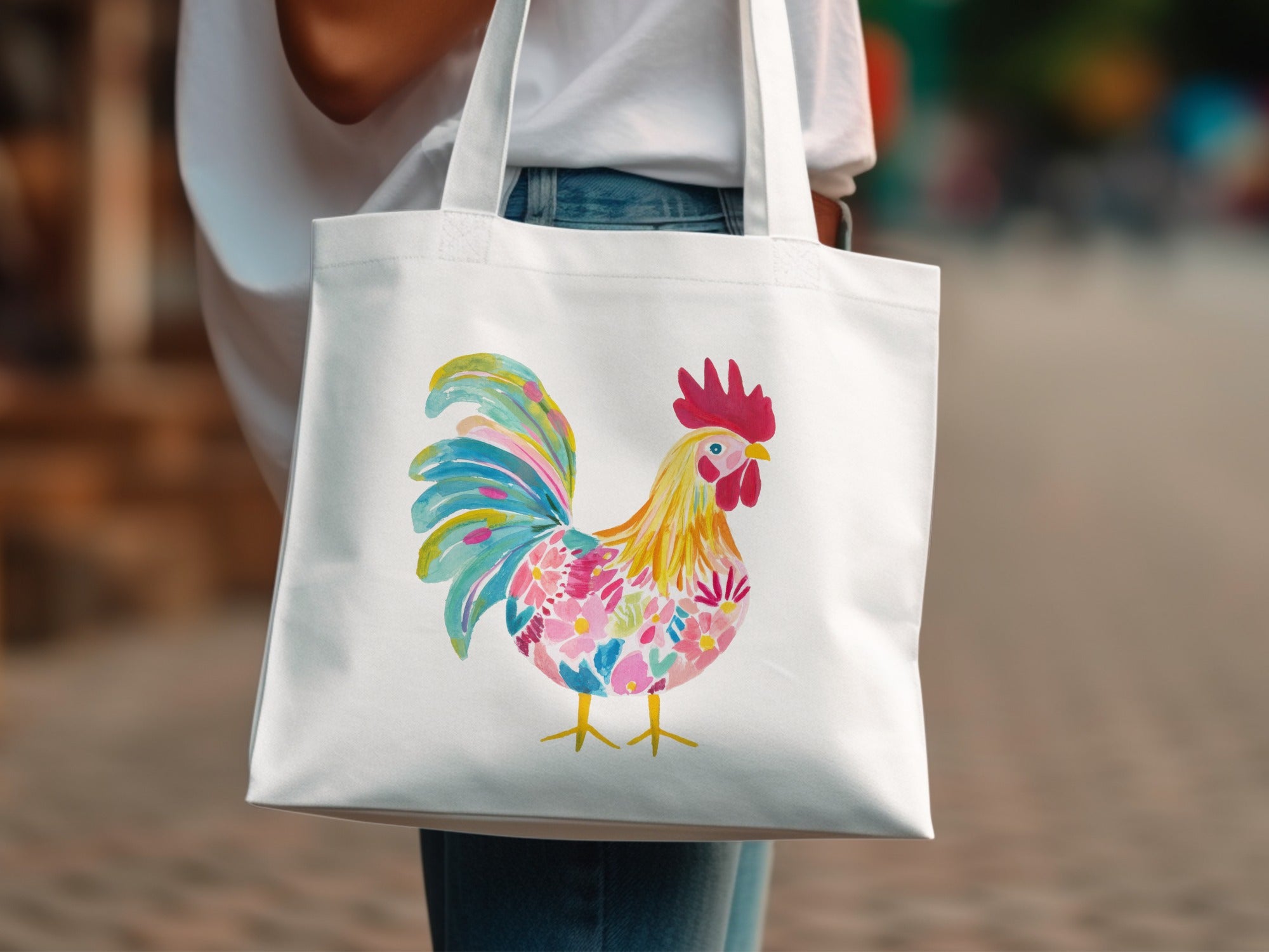 White tote bag with colorful rooster illustration.