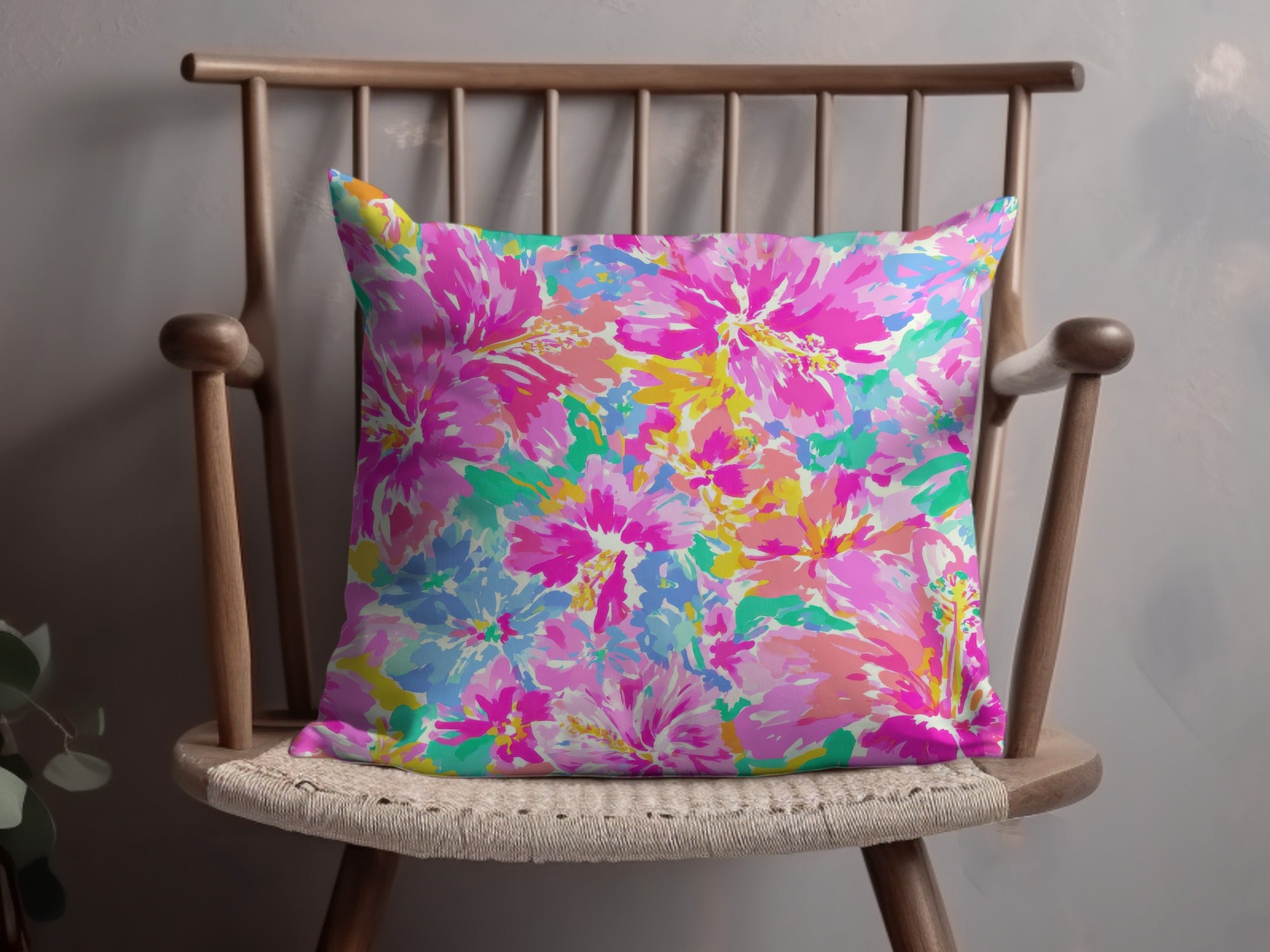 Pillow with a vibrant, abstract floral pattern in pinks and blues.