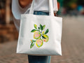 White tote bag with a painted lemon branch design.