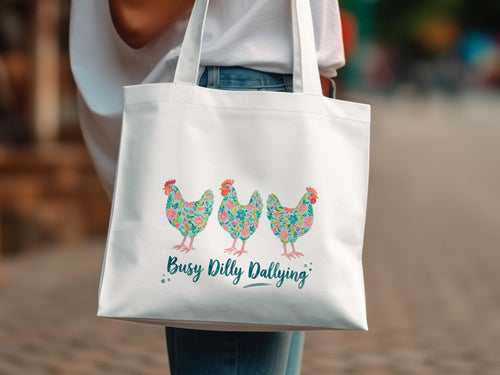 White tote bag with three floral chickens and text "Busy Dilly Dallying".