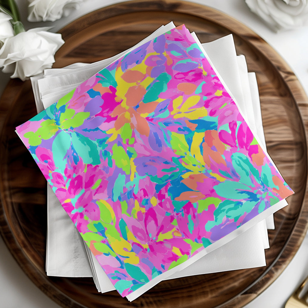 Colorful floral pattern on stacked white napkins on a wooden tray.