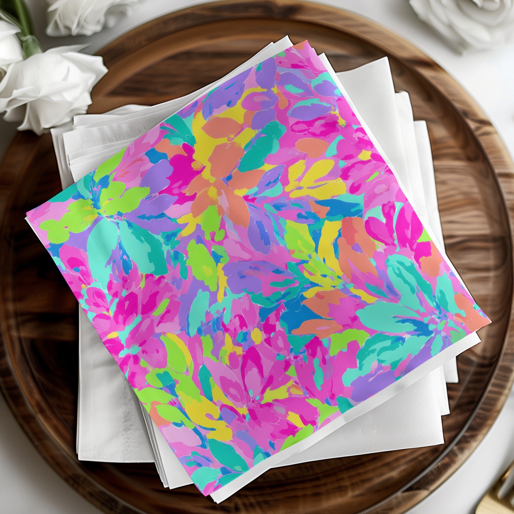 Colorful floral pattern on stacked white napkins on a wooden tray.