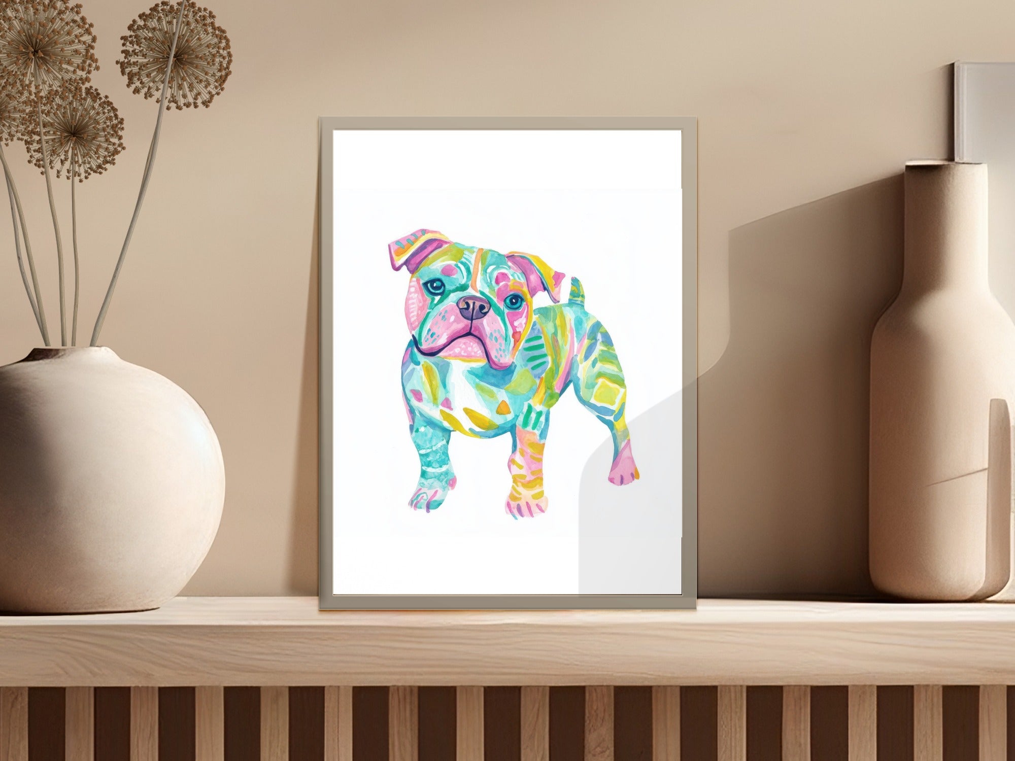 Colorful abstract bulldog painting in a frame on a shelf.