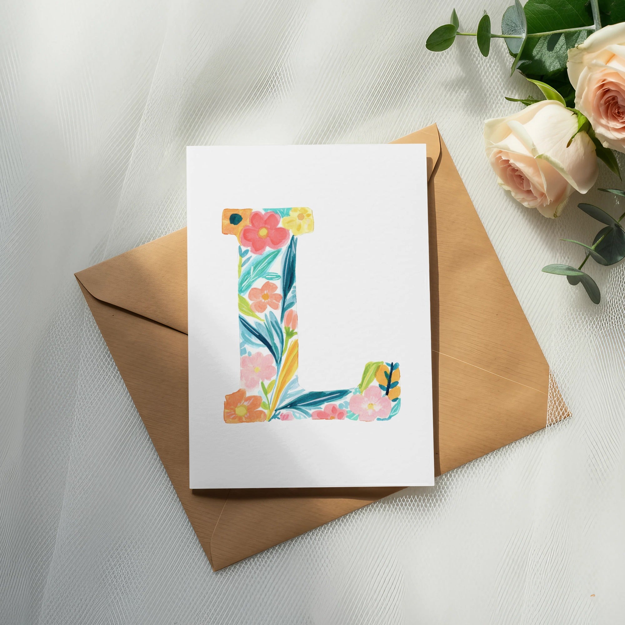 Floral letter "L" on card, with roses and eucalyptus.