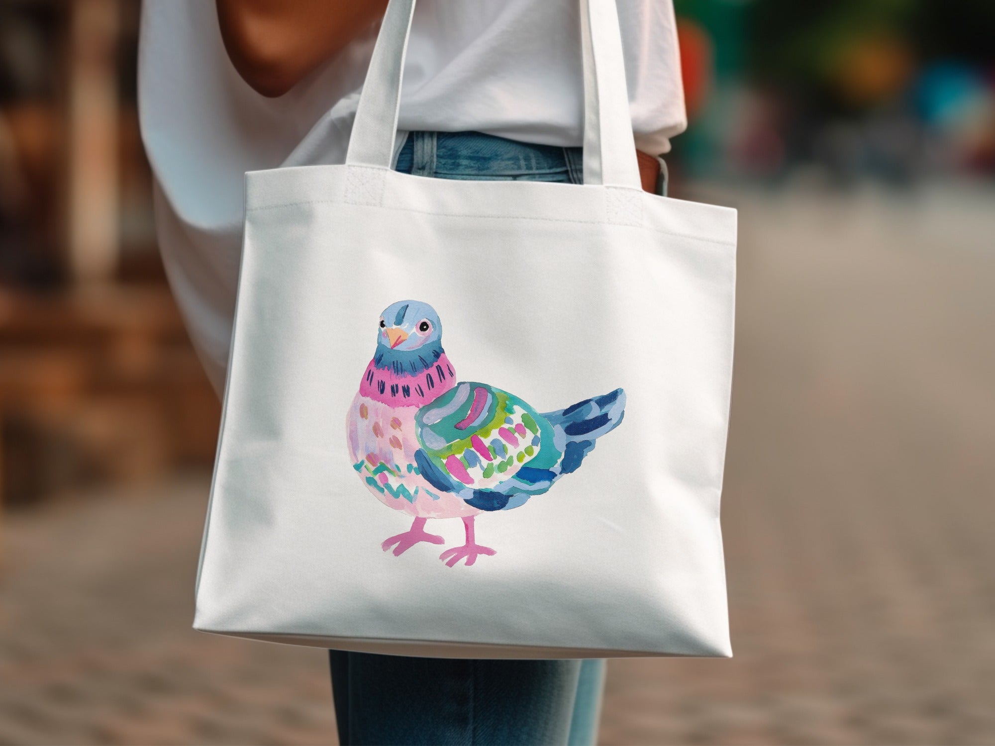 White tote bag with a colorful, stylized bird illustration.