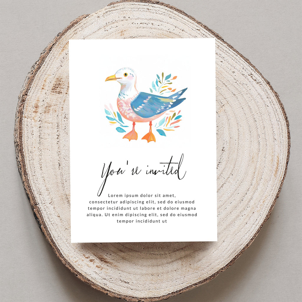 Watercolor seagull and "You're invited" text on card, centered on wood slice.