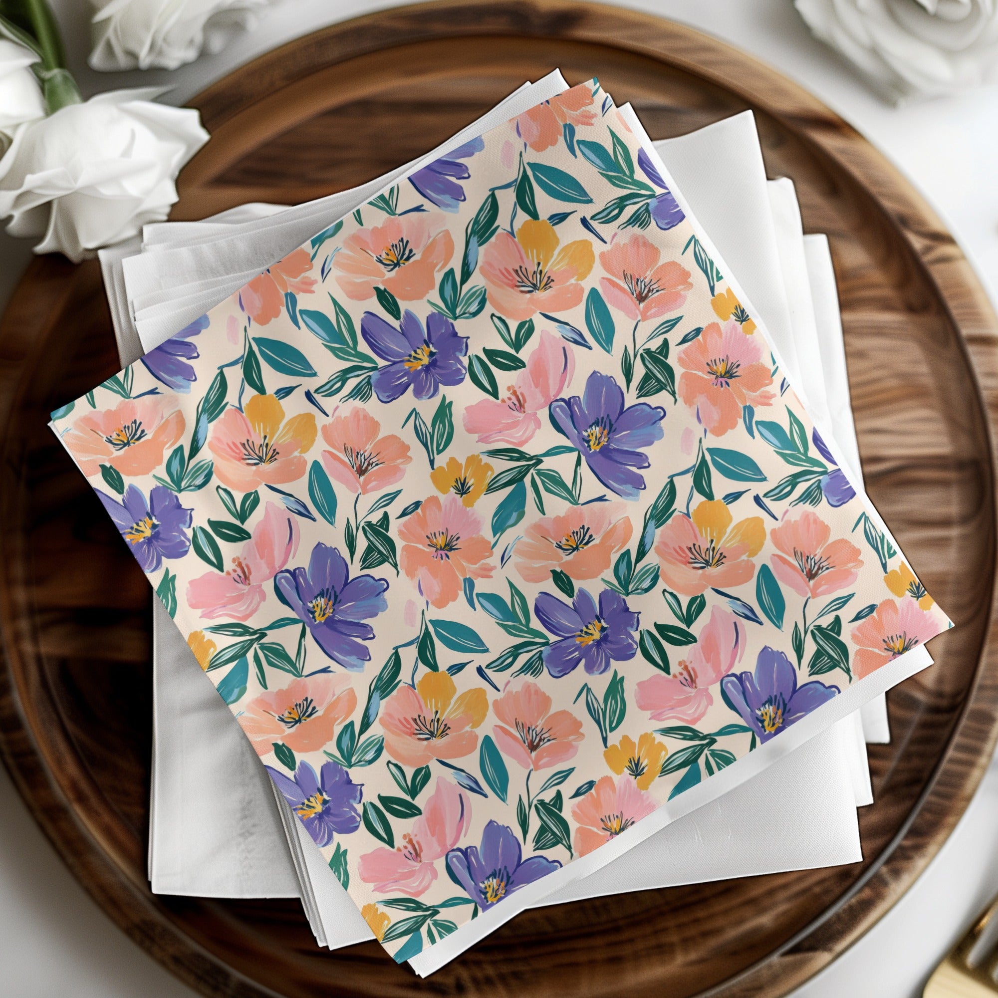 Floral patterned napkins with pink, purple, and yellow flowers on a white background.