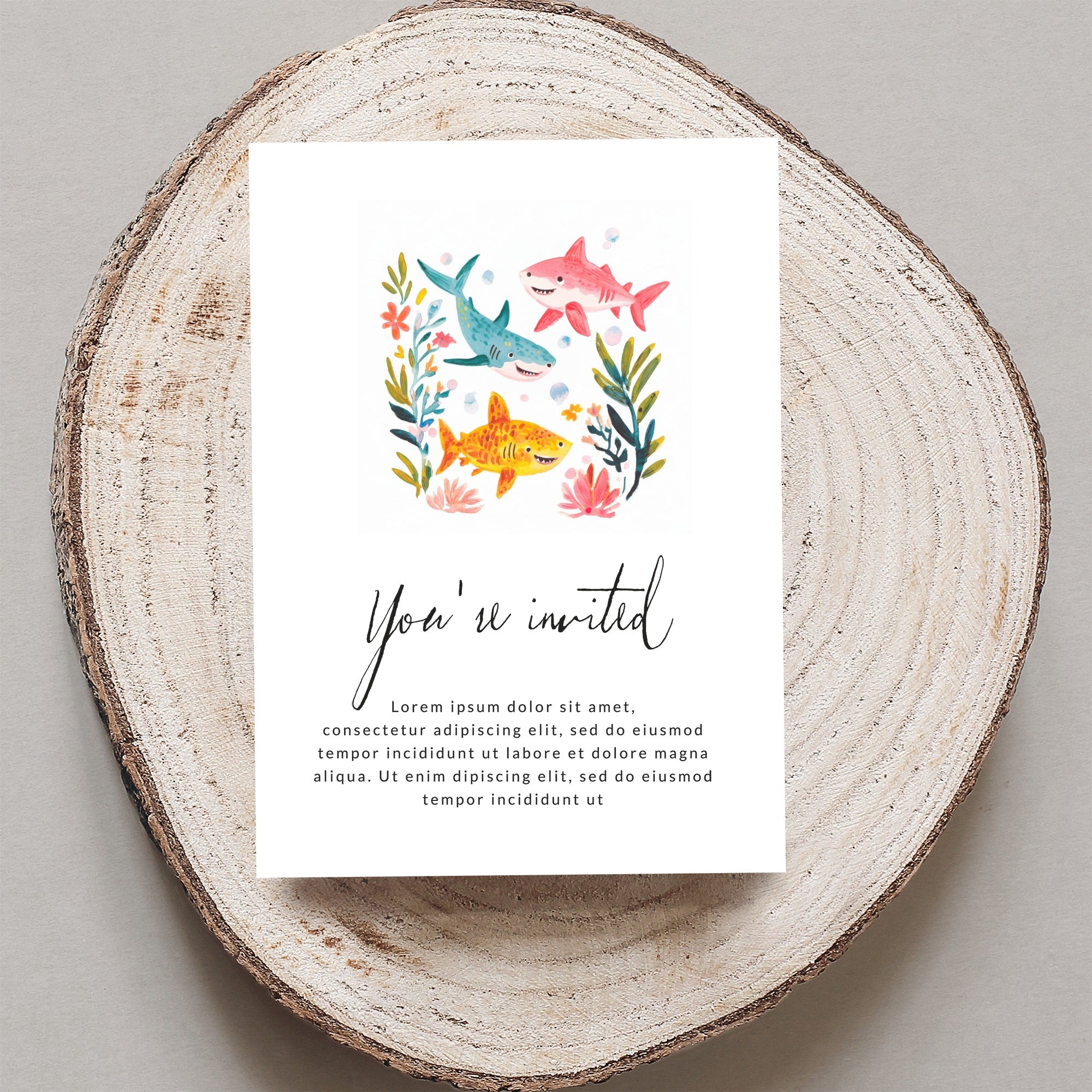 Invitation with sharks, fish, and flowers. "You're invited" text prominent.