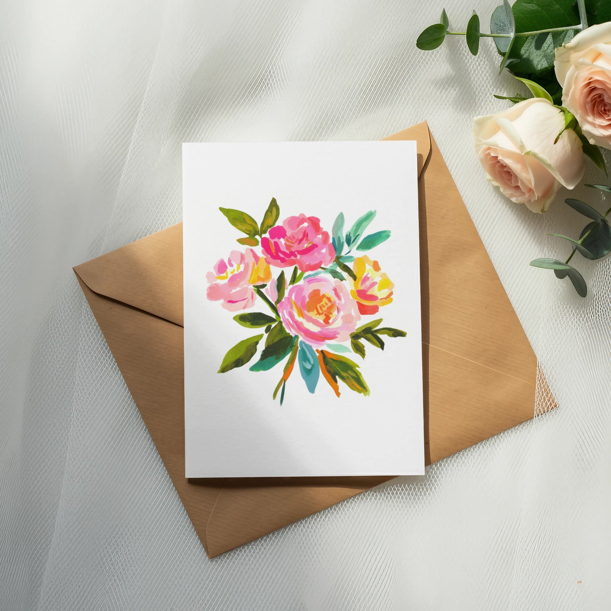 Watercolor floral bouquet on white card inside a brown envelope.