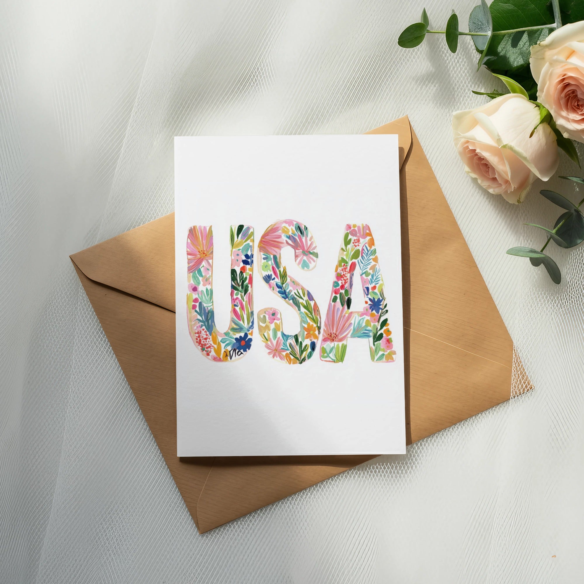 Card with "USA" in colorful floral letters on an envelope.