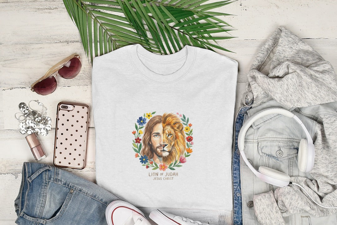White t-shirt with watercolor portrait of Jesus as the Lion of Judah surrounded by flowers.