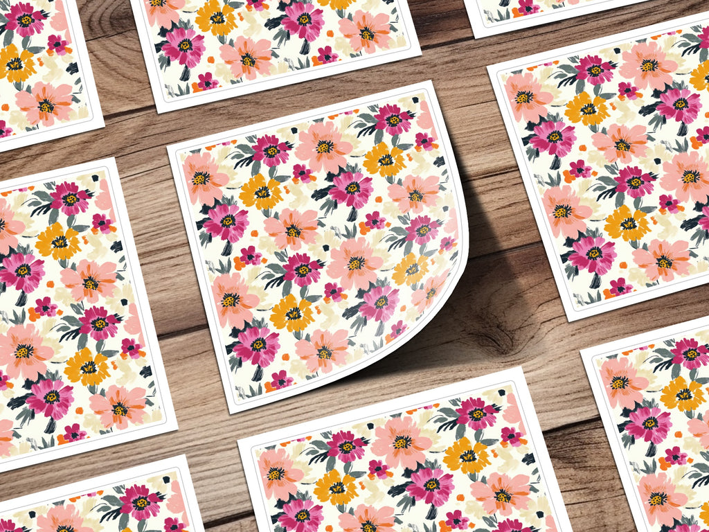 Floral pattern on cards with warm colors on a wooden background.