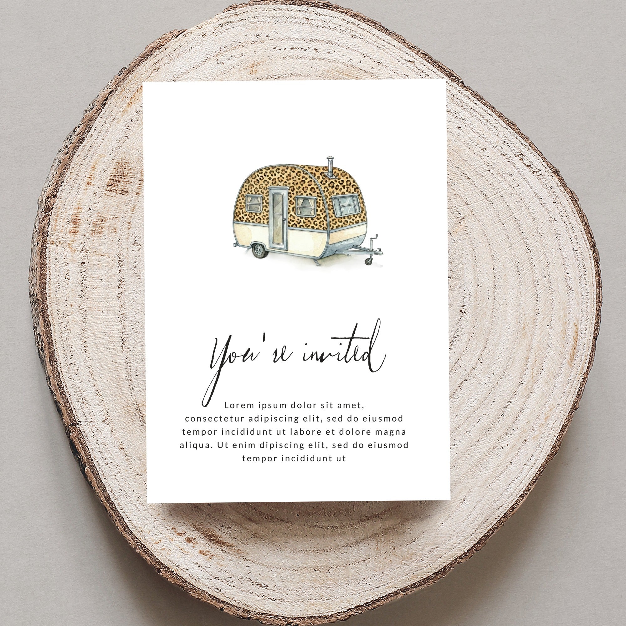 Invitation with leopard print caravan and "You're invited" text.