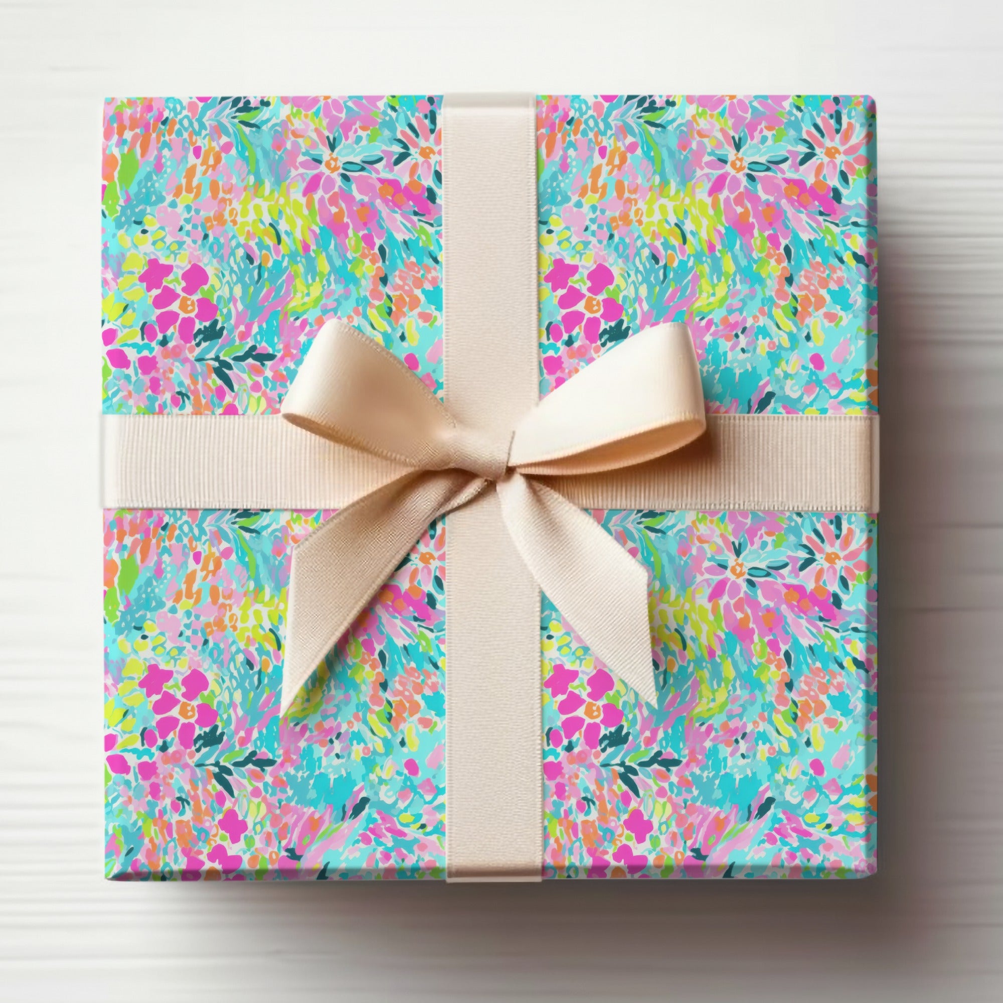 Gift box with vibrant floral pattern and cream ribbon bow.