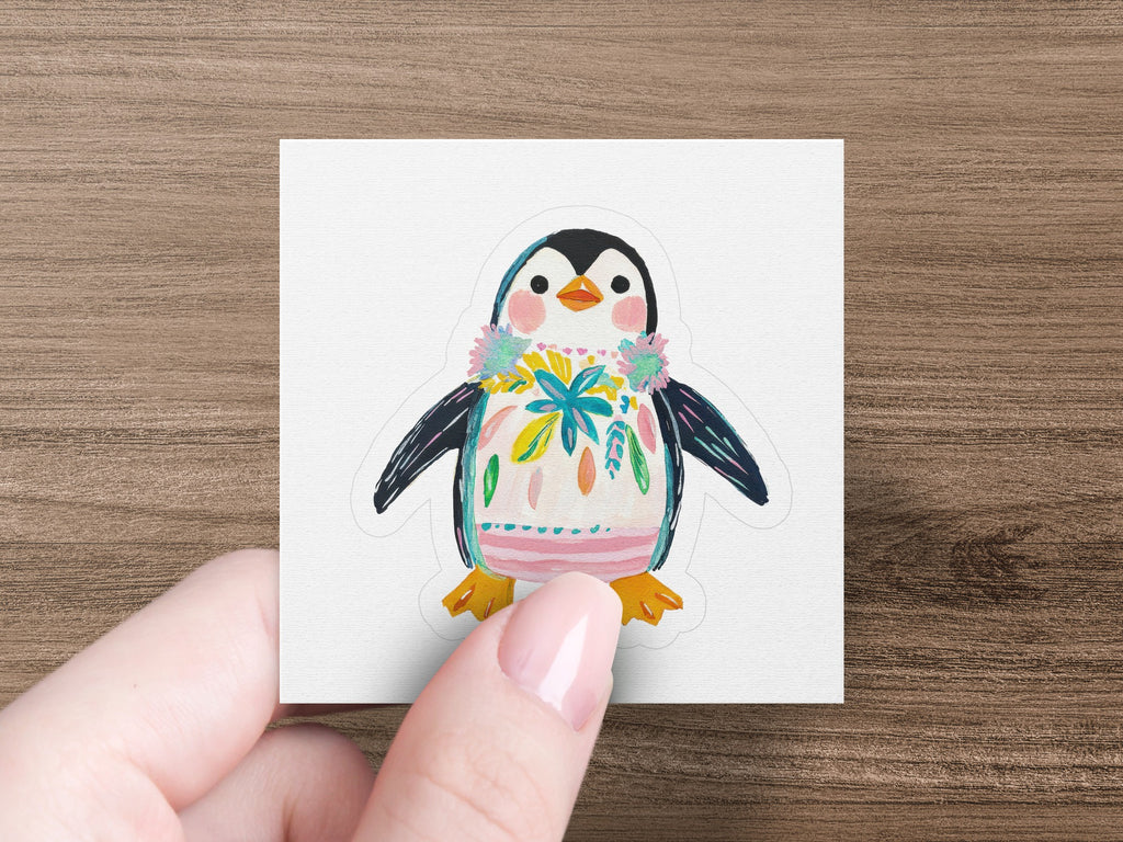 Penguin sticker with floral lei and colorful painted body.