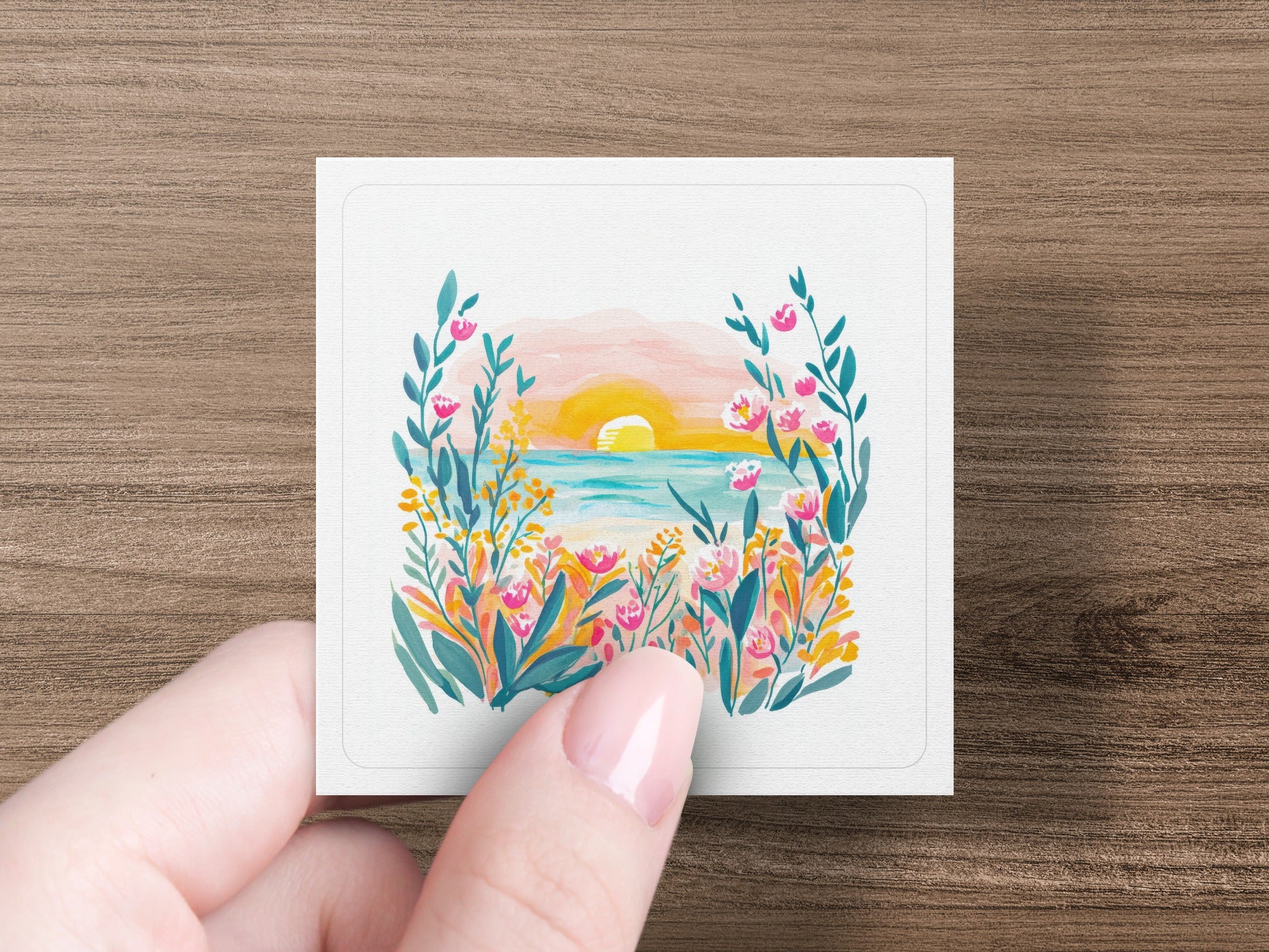 Watercolor painting of a sunset over the ocean framed by colorful flowers and foliage.