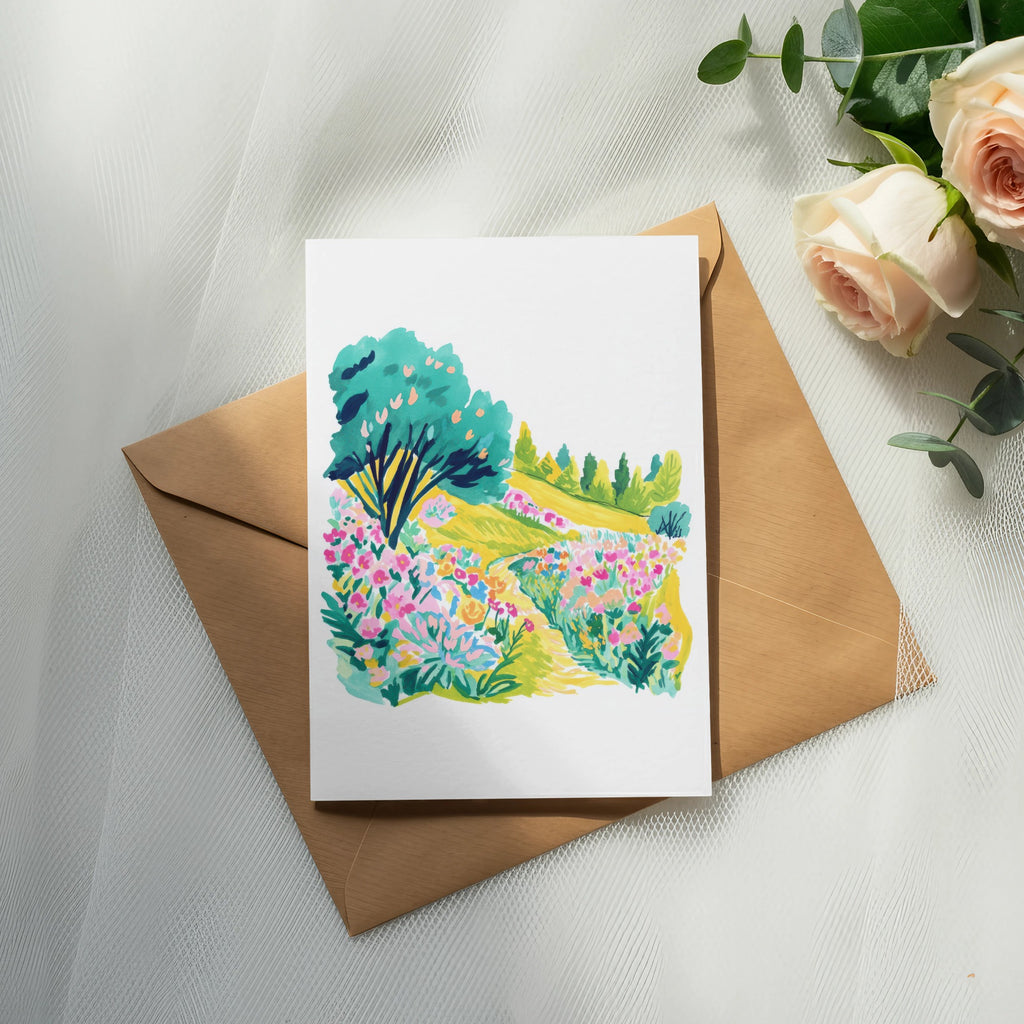 Watercolor painting of a colorful garden path on a card resting on an envelope.