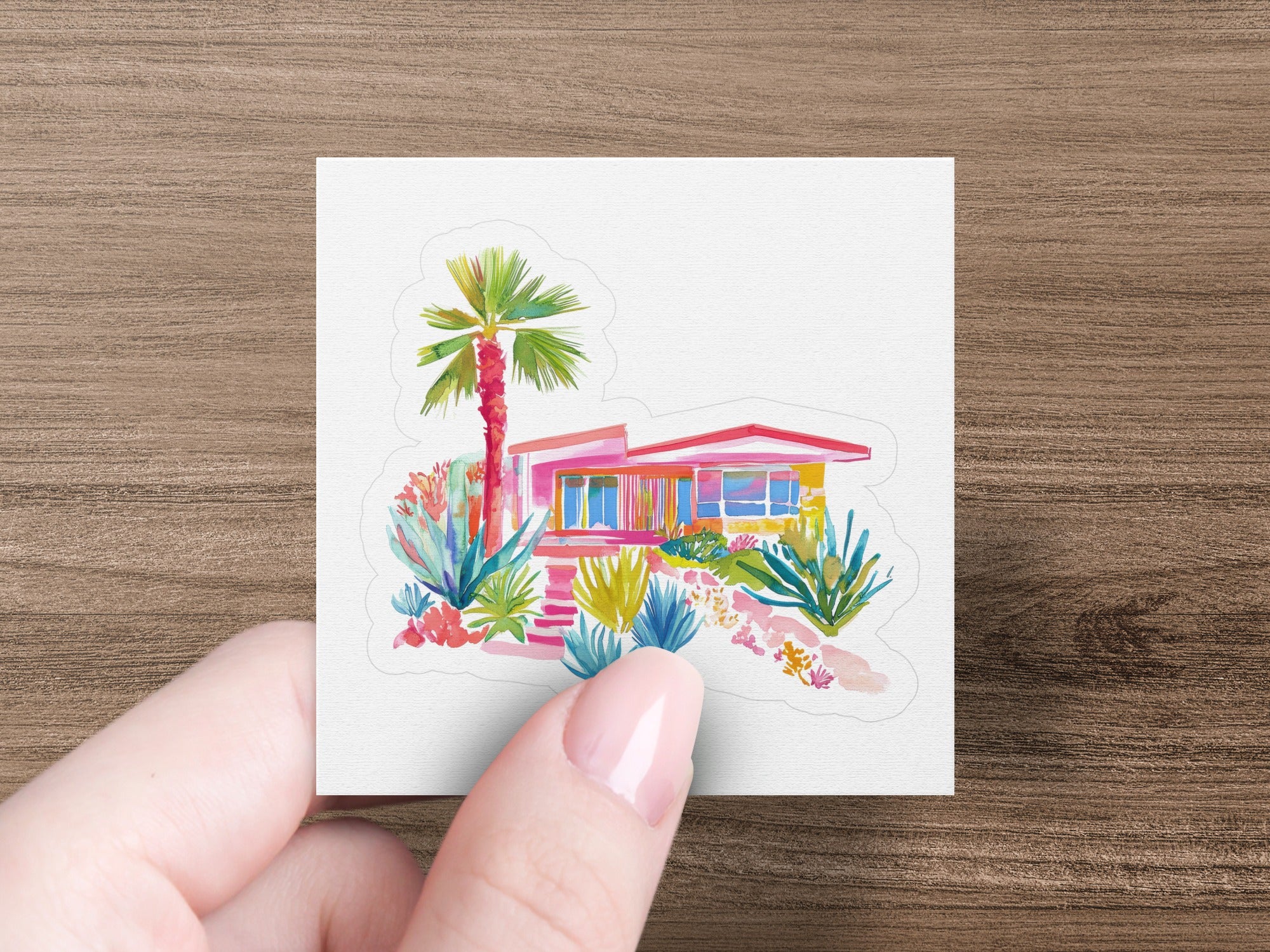 Mid-century modern house with palm tree and colorful desert plants.