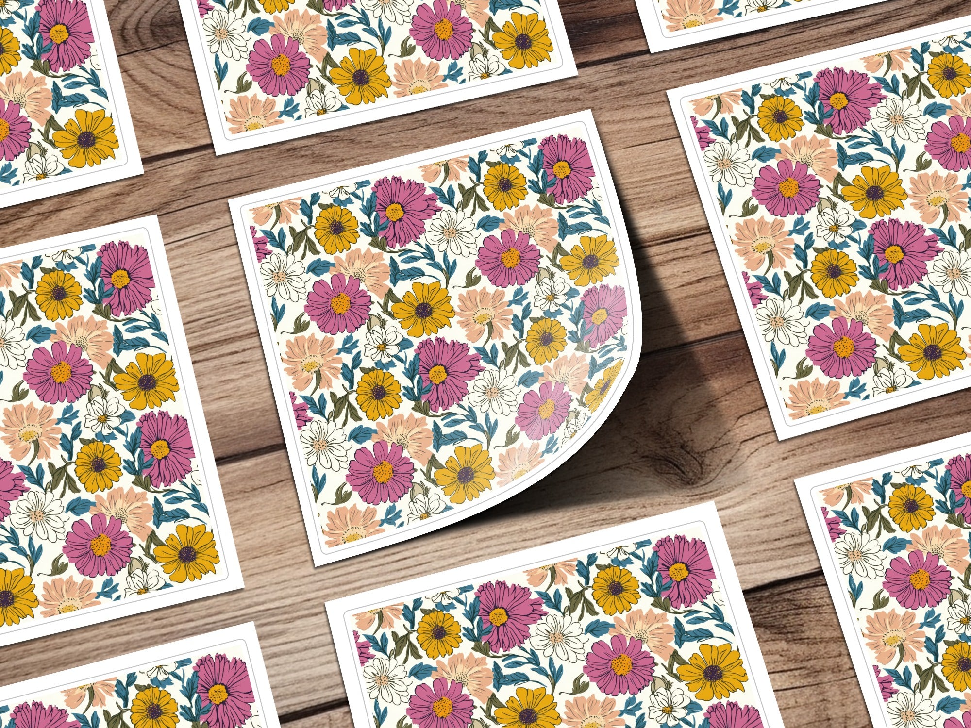 Floral pattern stickers on a wooden background, arranged in a grid.