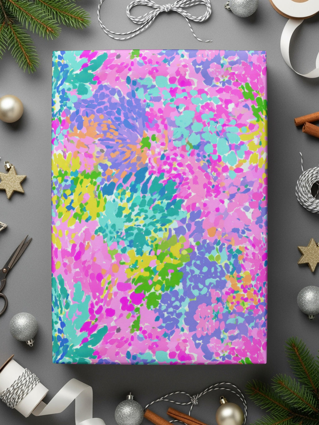 Colorful abstract floral wrapping paper with silver ribbon and ornaments.