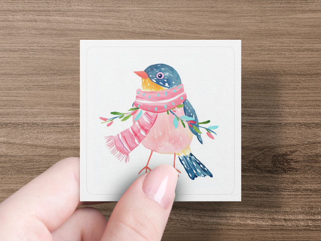 Watercolor bird with pink scarf and green branches on white card.