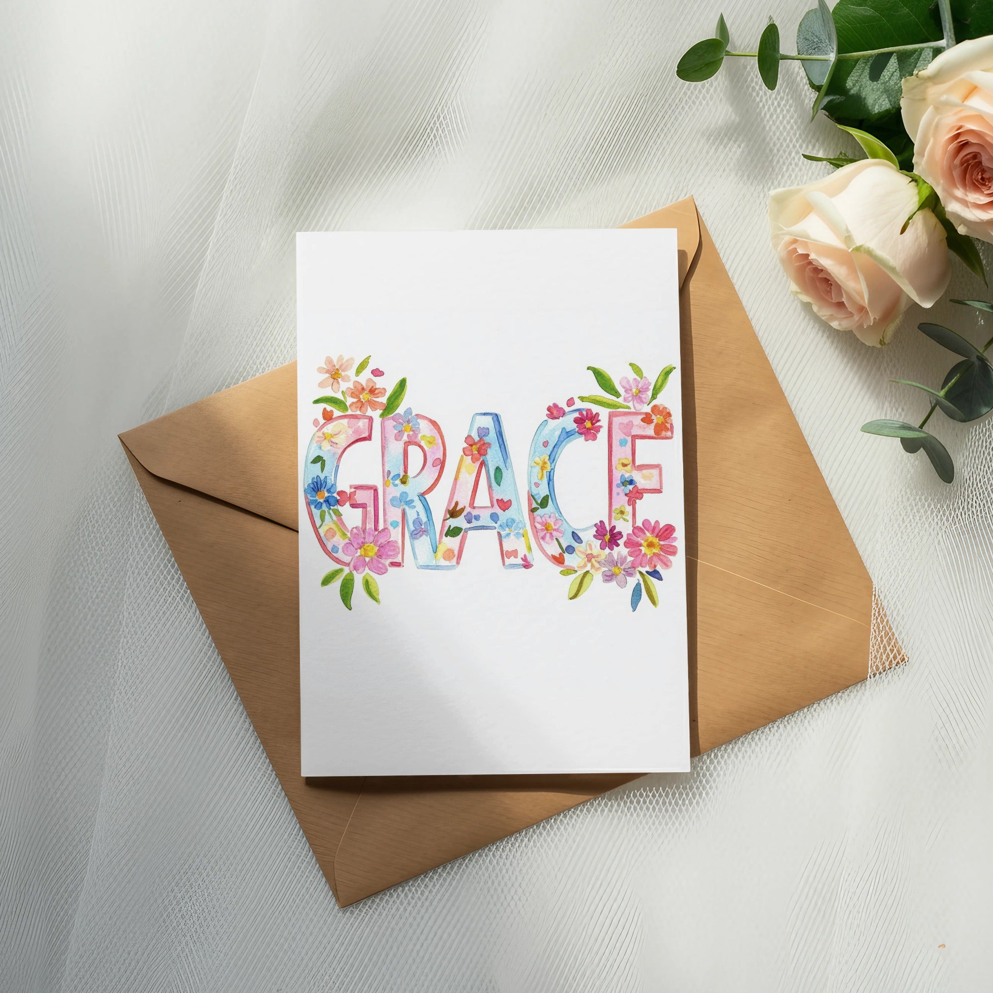 "Grace" written in colorful floral watercolor letters on a card.