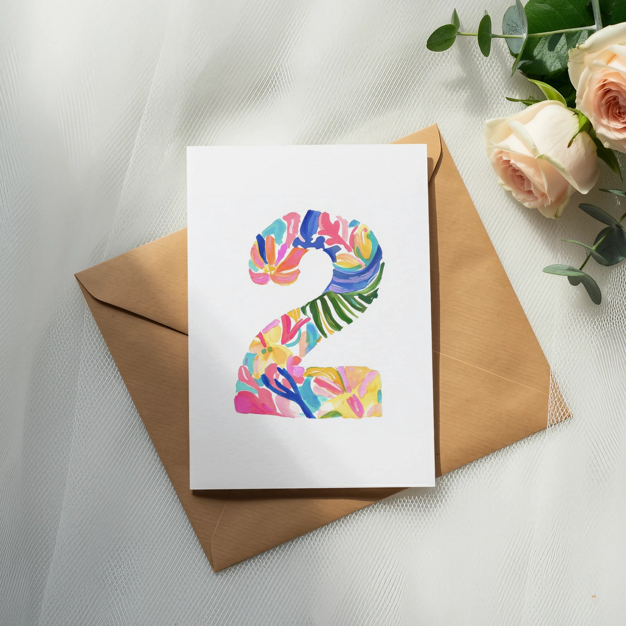 Card with a colorful floral number "2" on a brown envelope.