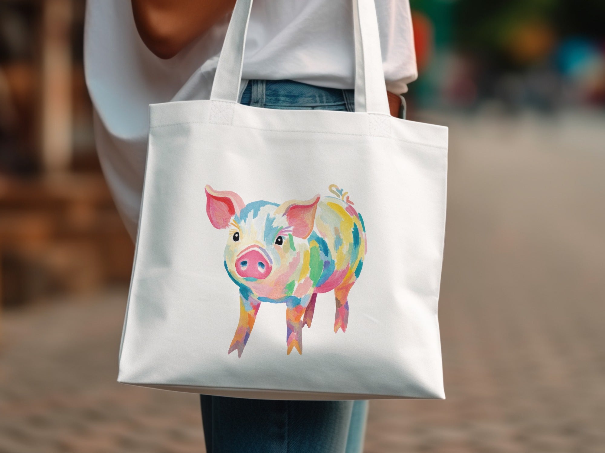 White tote bag with a colorful watercolor pig illustration.