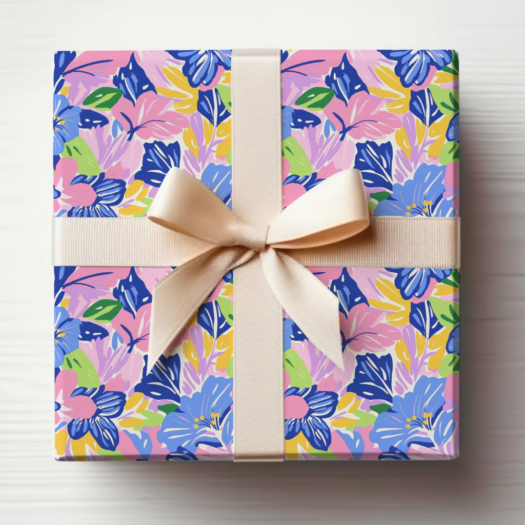Gift box with a floral pattern, tied with a cream ribbon.