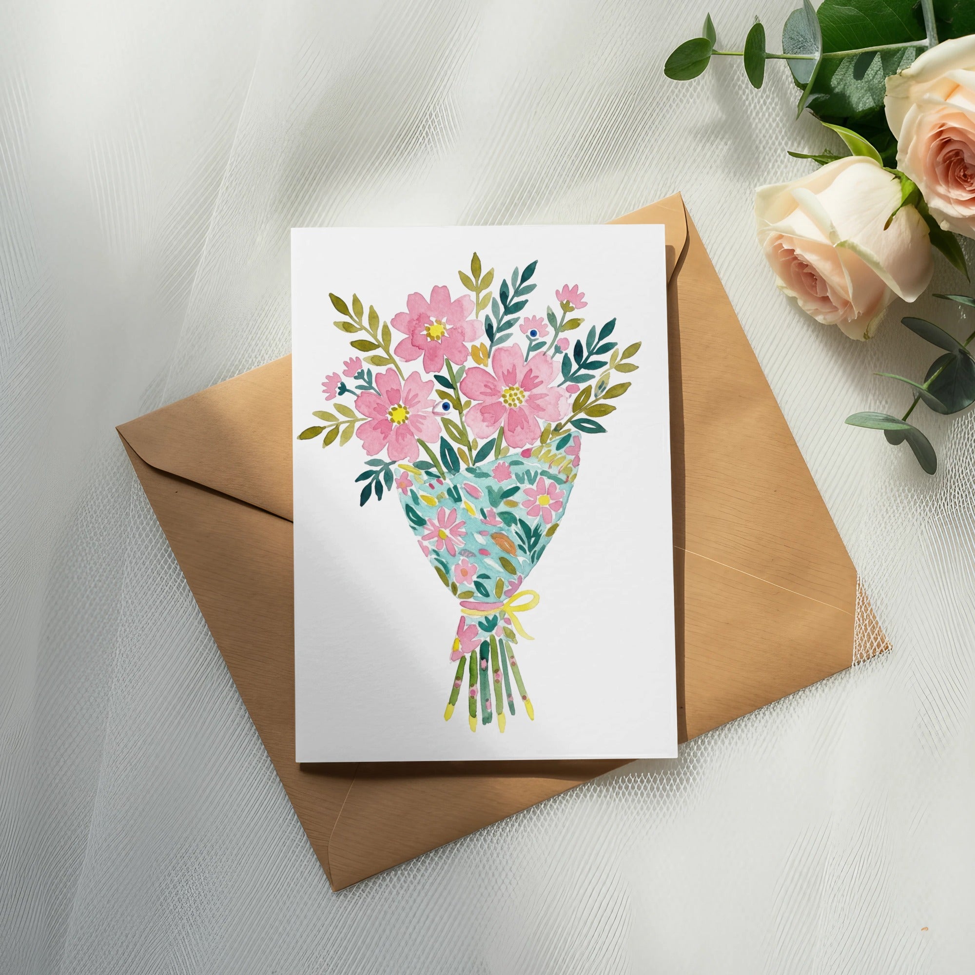 Watercolor bouquet of pink flowers with green leaves on a card.