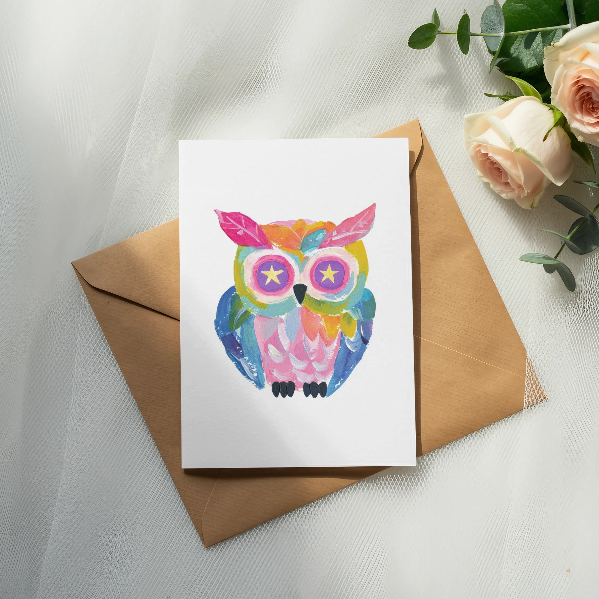 Colorful painted owl illustration on a card with a brown envelope.