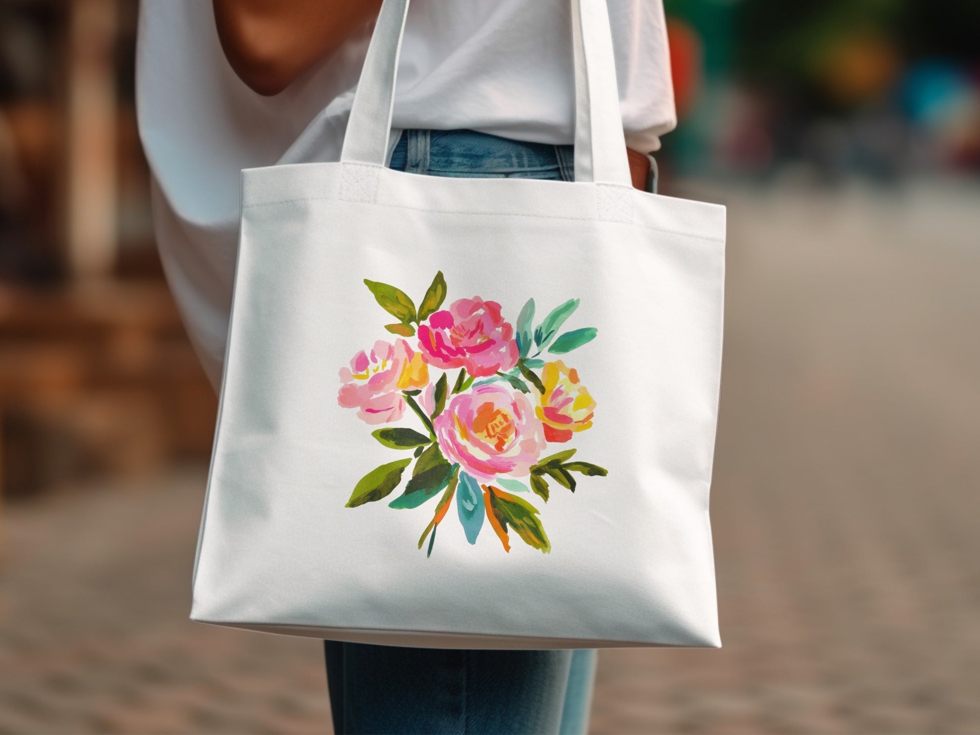White tote bag with a colorful floral watercolor painting.