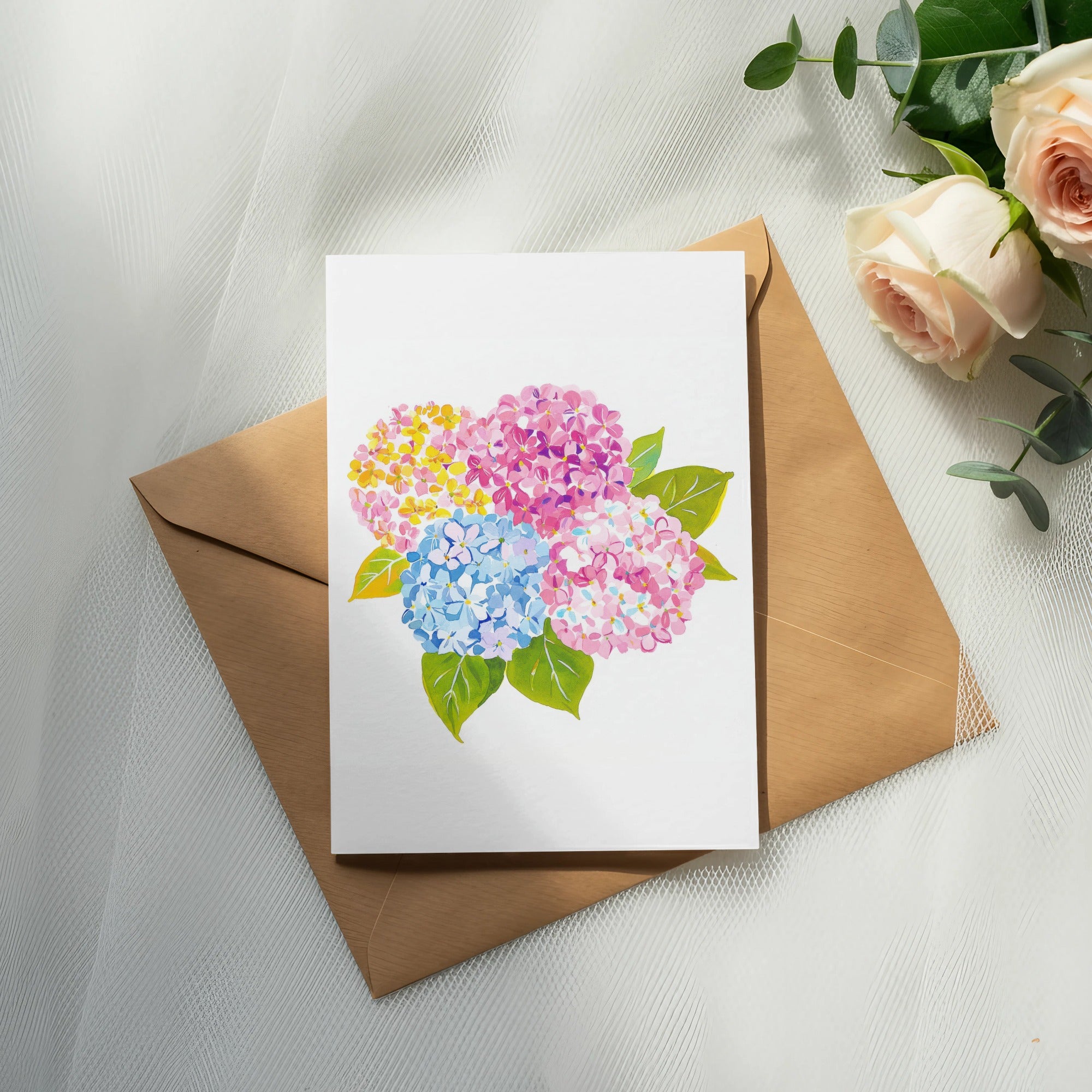 Card with colorful hydrangeas on brown envelope and roses.