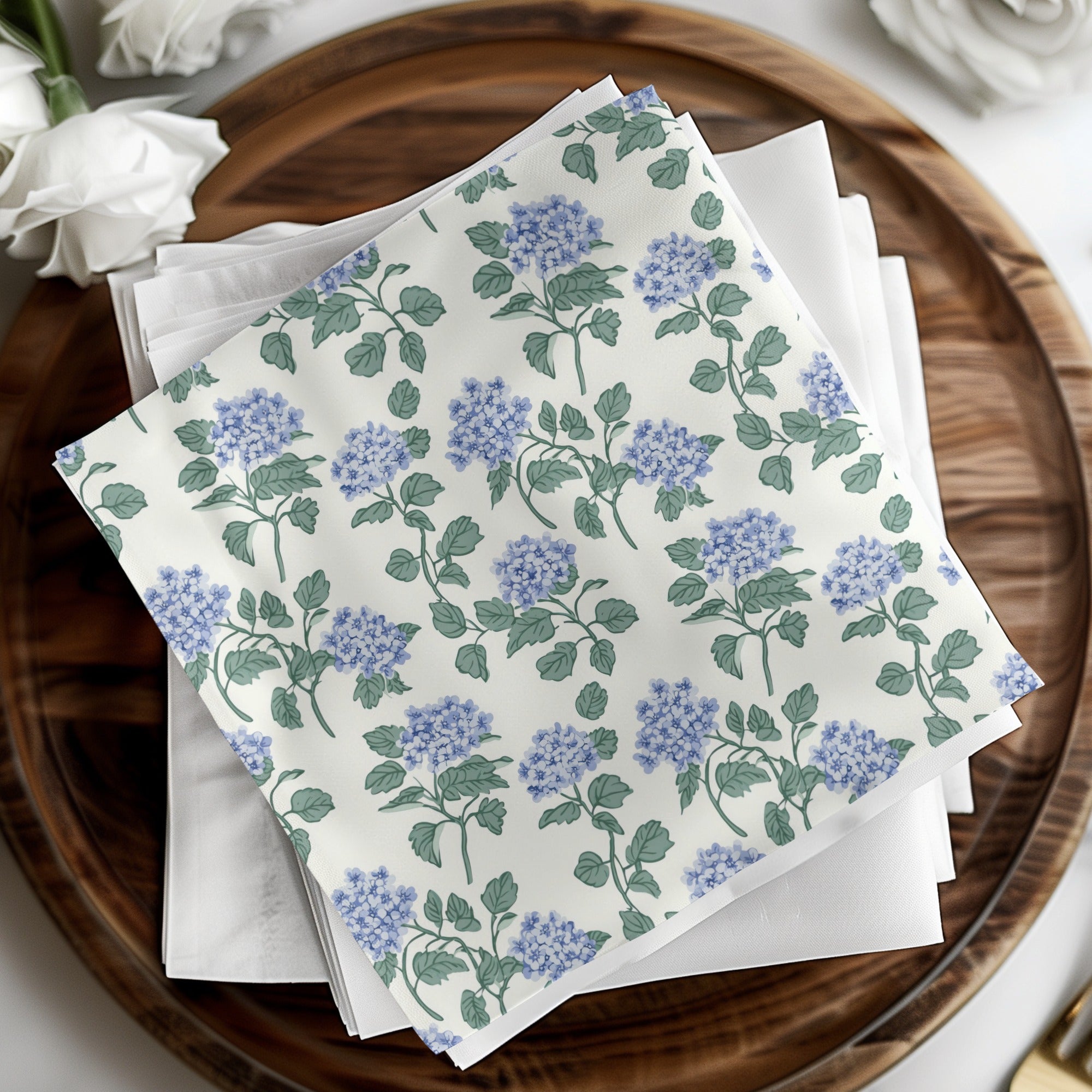 White napkins with a blue hydrangea floral pattern.