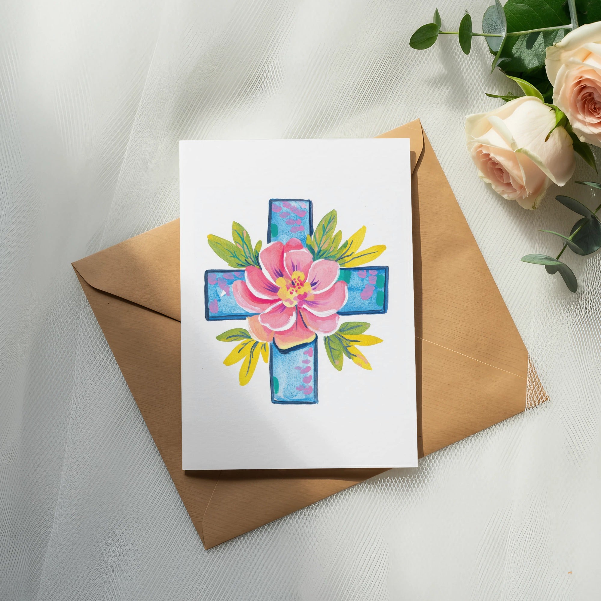 Watercolor cross with pink flower and green leaves on card, on envelope.