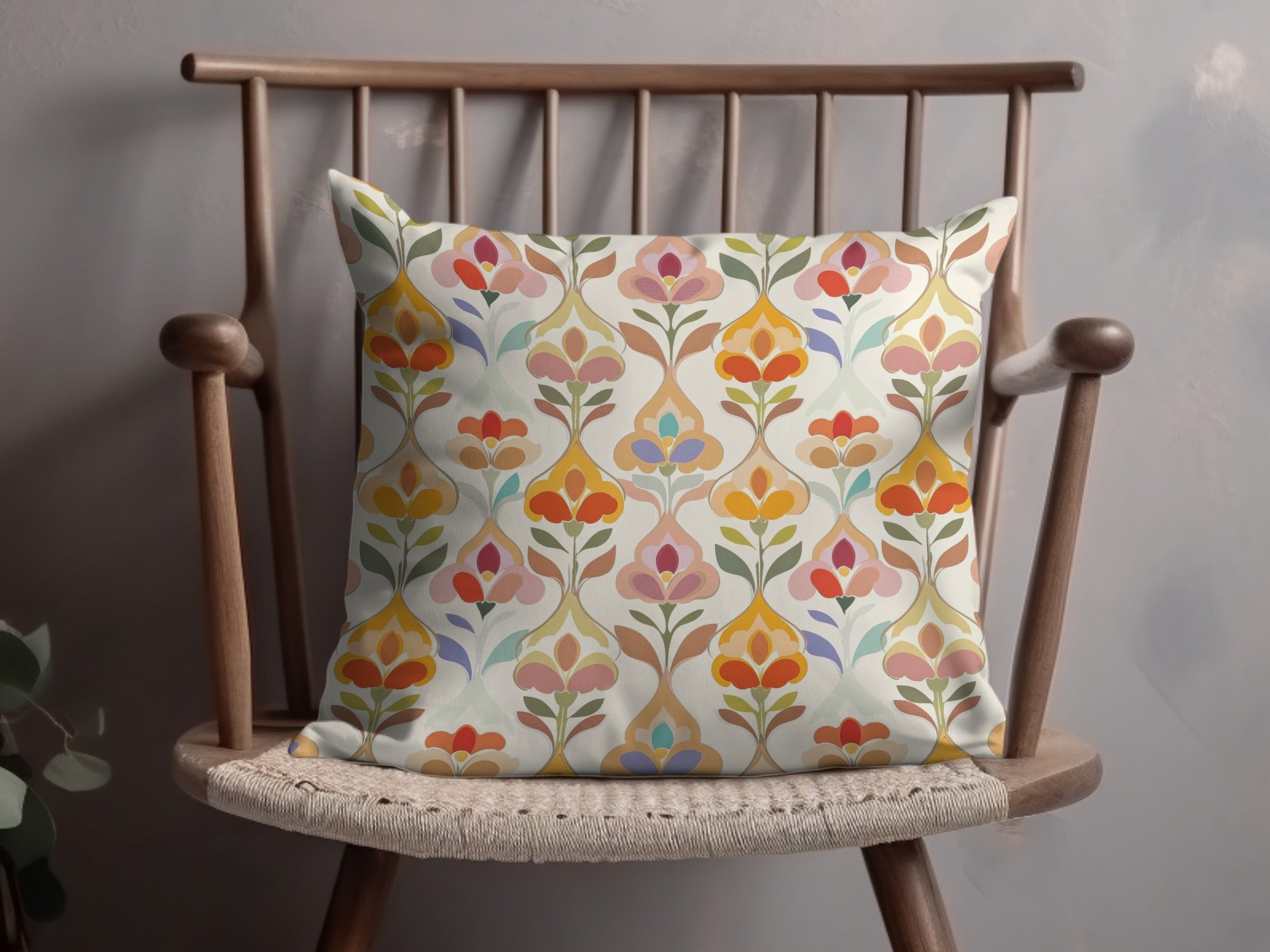 Decorative throw pillow with a colorful floral pattern on a wooden chair.
